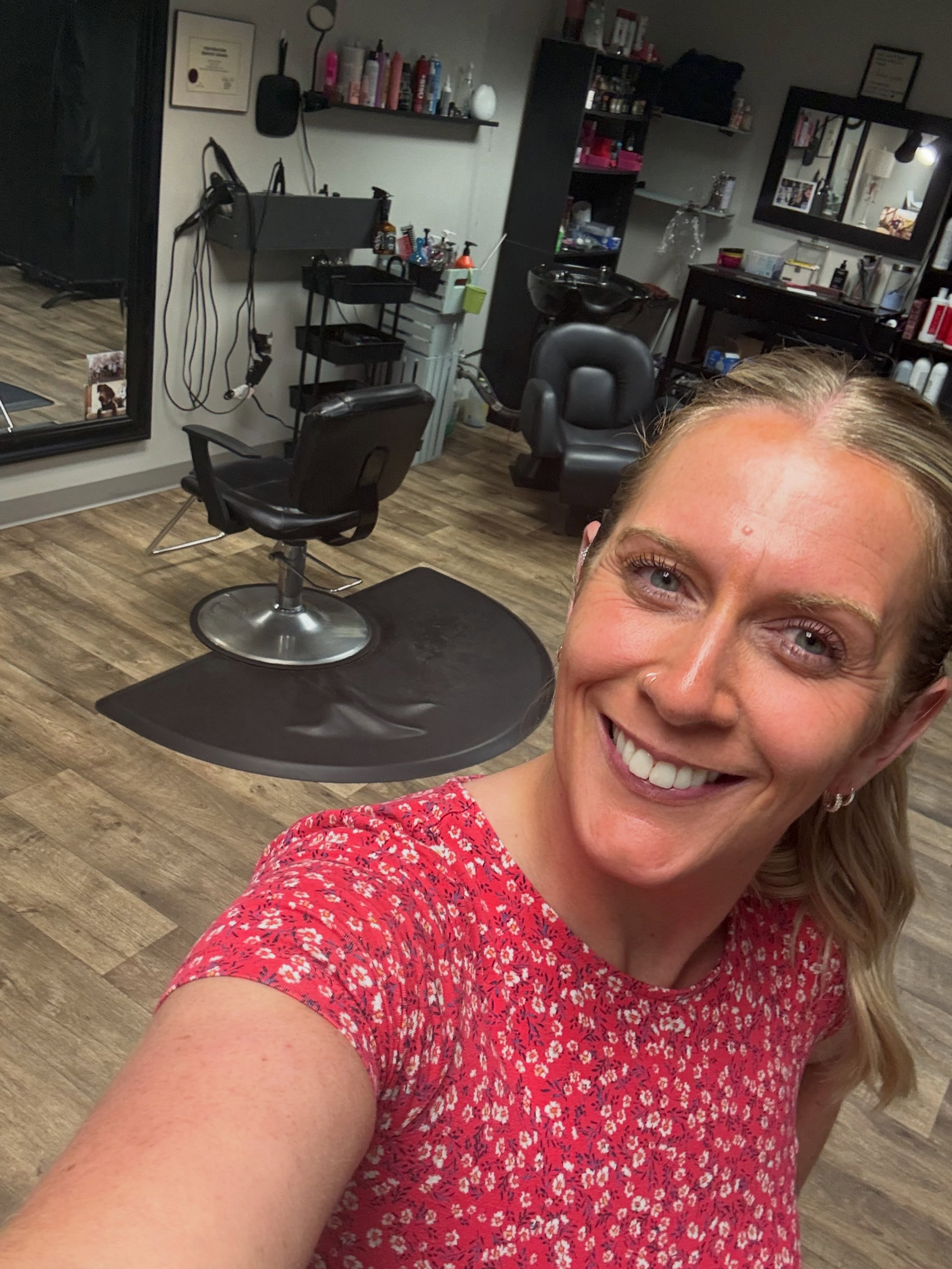 Hair by D stylist smiling inside the salon